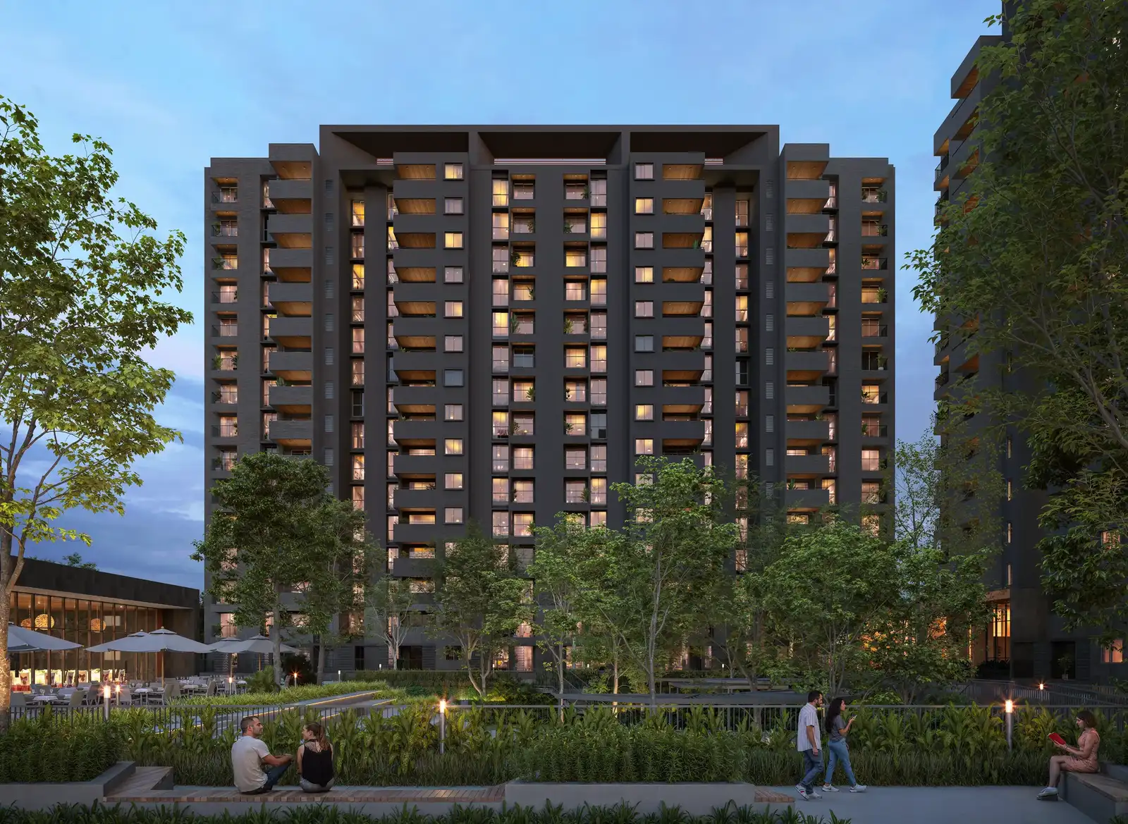 Dark-toned tower above a landscaped courtyard at dusk