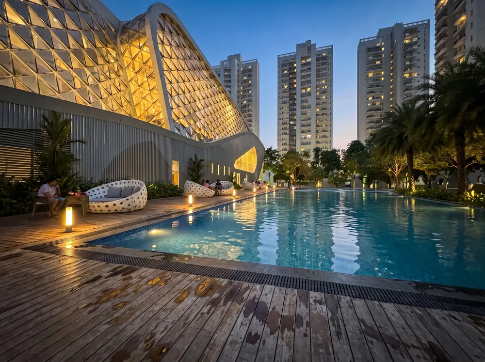 Twilight exterior with clubhouse pool — Godrej Crown (4 of 5)