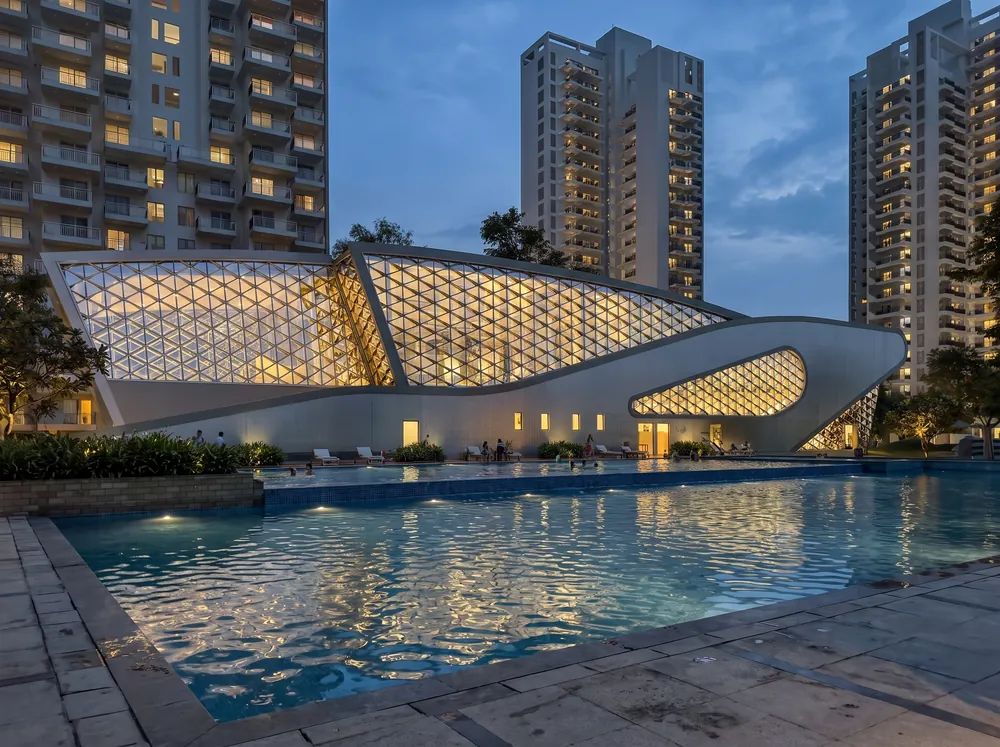 Twilight exterior with clubhouse pool — Godrej Crown (5 of 5)